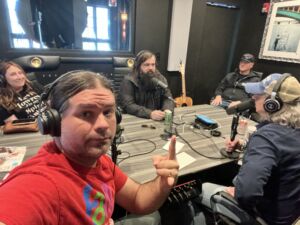 Photo of Stephanie & Levi Lowrey, Grant Walden, and host Paul Stanley recording a podcast episode.