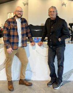 Jeff Daniels with Non-Fiction Coffee and Paul Stanley of OneSouthernMedia poses at a coffee shop.